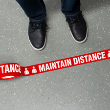 Maintain distance floor tape in front of a pair of feet